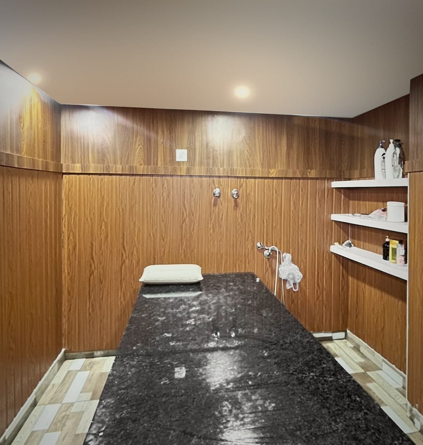 The Moroccan bath room, with a polished granite table set against wood panelling